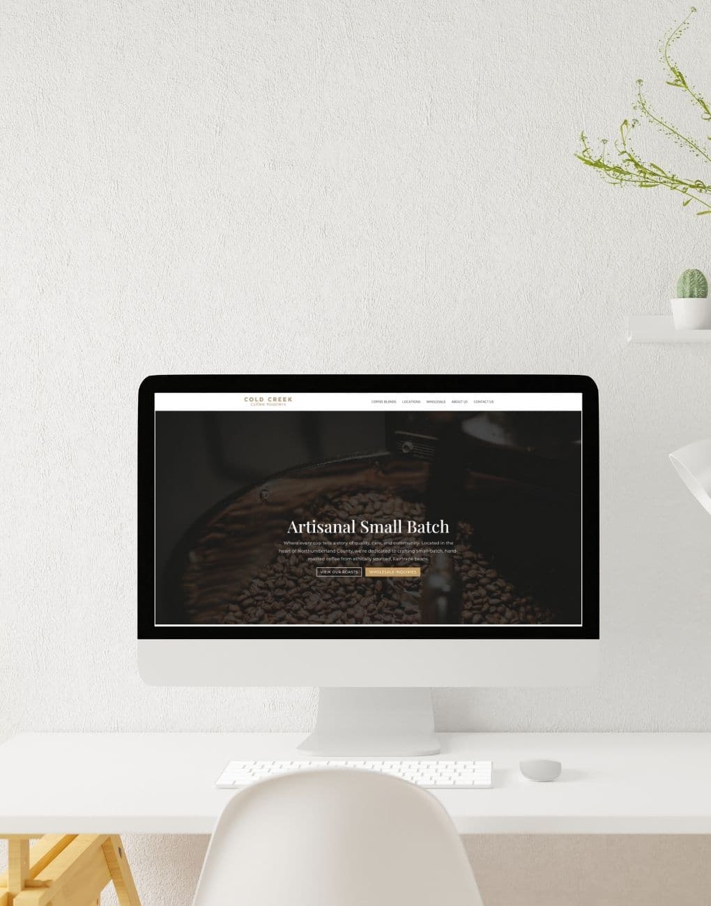 A modern website mockup displayed on an iMac, featuring a clean, minimalist design for Cold Creek Coffee Roasters, an artisanal small-batch coffee brand